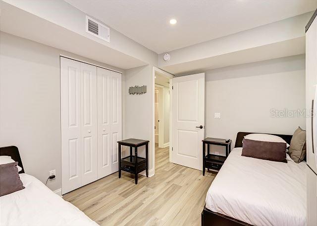 bedroom featuring light wood-type flooring and a closet