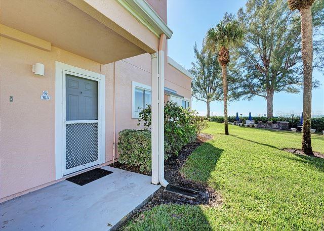 property entrance featuring a yard and a patio