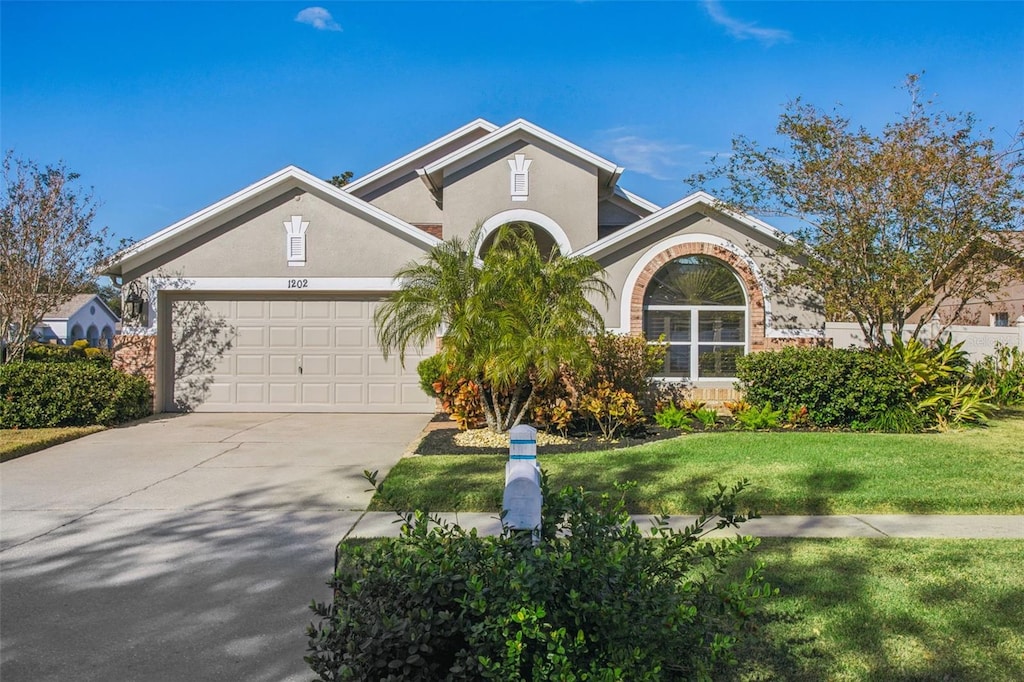 view of front of house featuring a garage and a front yard