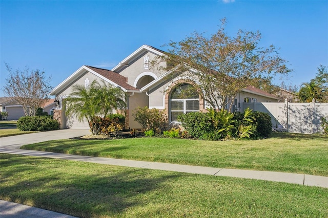 view of front of house featuring a garage and a front lawn