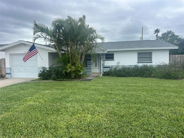 single story home featuring a garage and a front lawn