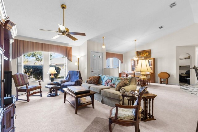 living room featuring light carpet, vaulted ceiling, and ceiling fan