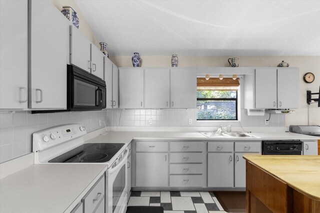 kitchen featuring sink, backsplash, and black appliances