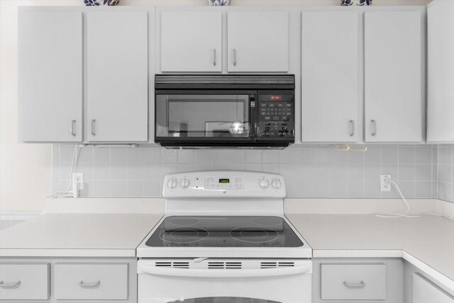 kitchen featuring white cabinetry, decorative backsplash, and electric range