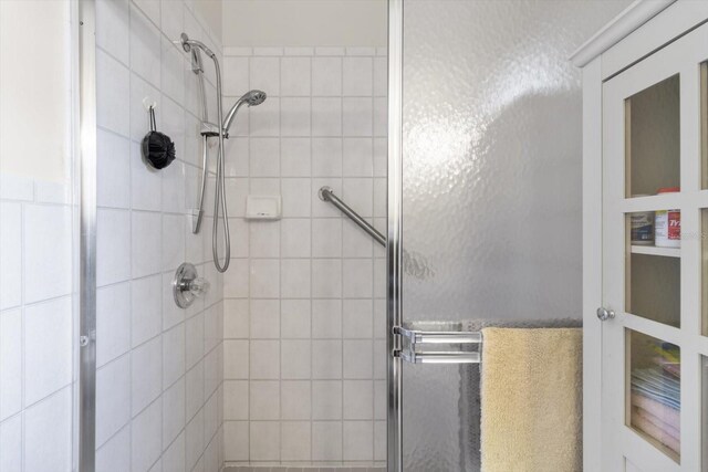 bathroom featuring a shower with shower door