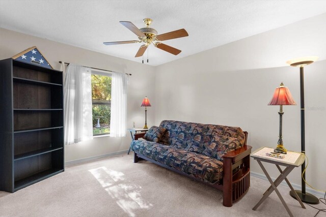 living room with light colored carpet and ceiling fan