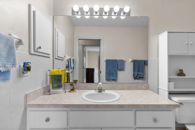 bathroom featuring decorative backsplash, vanity, and toilet