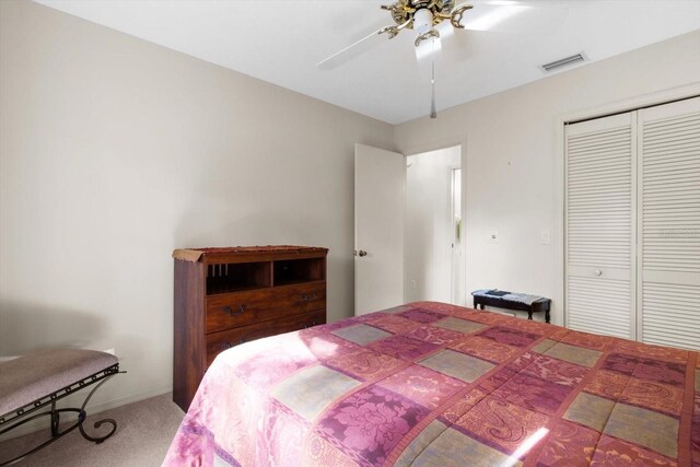 bedroom with carpet, ceiling fan, and a closet