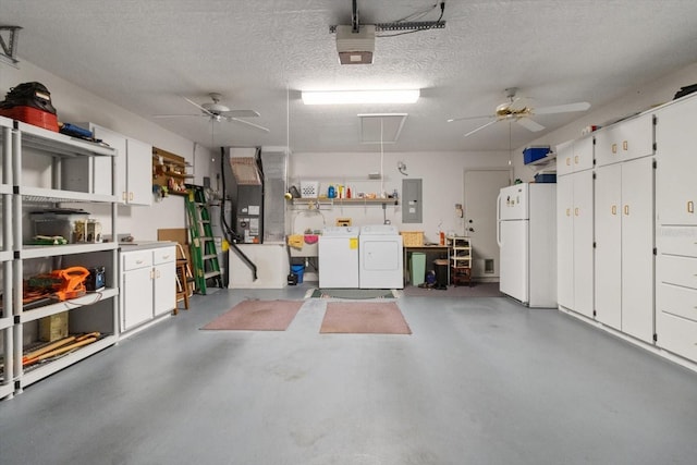 garage with ceiling fan, washer and dryer, white refrigerator, electric panel, and a garage door opener