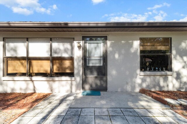 entrance to property with a patio area