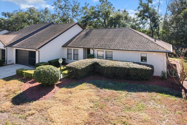 single story home with a garage and a front yard