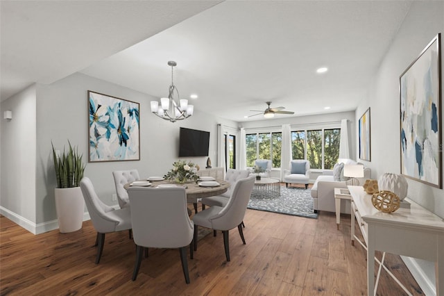 dining area featuring hardwood / wood-style flooring and an inviting chandelier