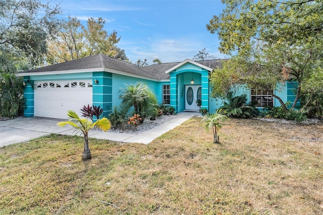 ranch-style house featuring a front yard and a garage