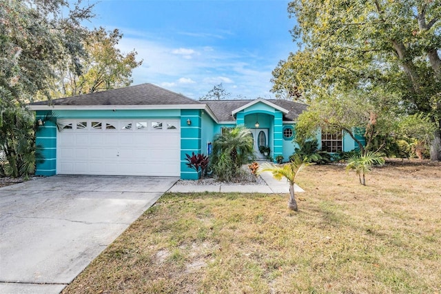 ranch-style home with a front yard and a garage