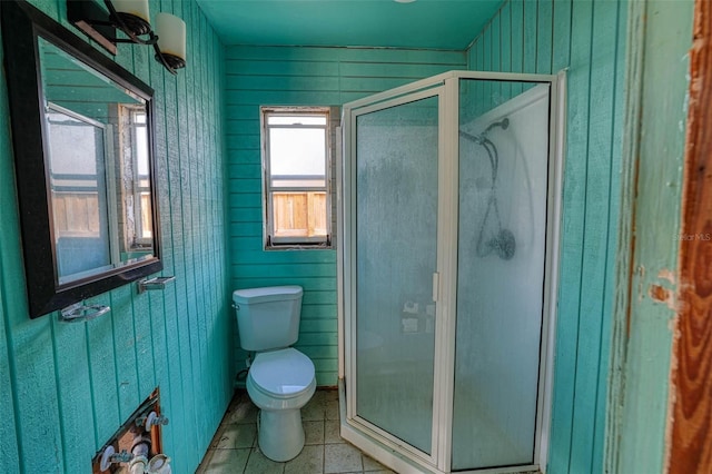 bathroom with tile patterned flooring, an enclosed shower, and toilet