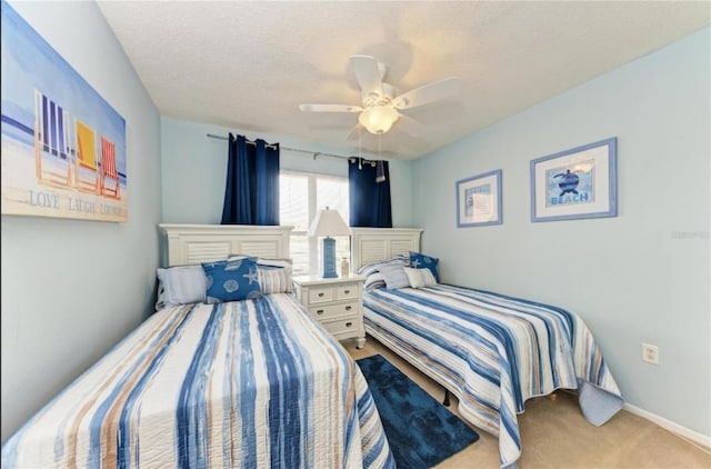 carpeted bedroom featuring a textured ceiling and ceiling fan