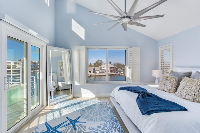 bedroom featuring multiple windows, high vaulted ceiling, access to outside, and ceiling fan