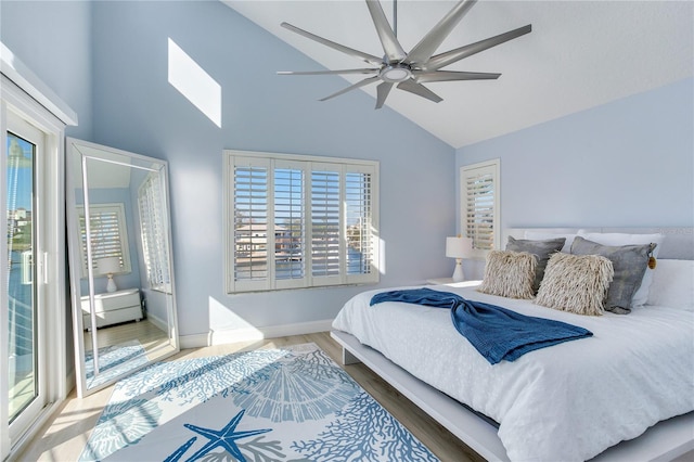 bedroom featuring multiple windows, wood-type flooring, high vaulted ceiling, and ceiling fan