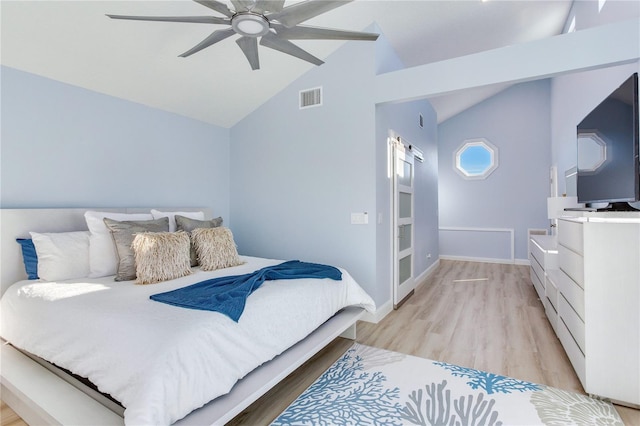 bedroom featuring ceiling fan, light hardwood / wood-style floors, and lofted ceiling