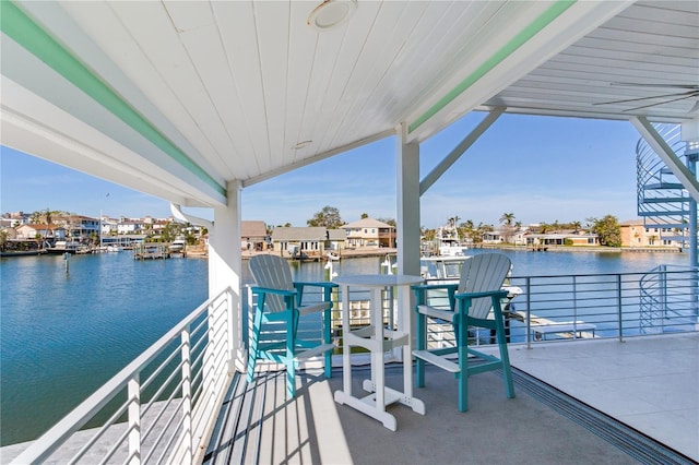 view of patio / terrace with a water view and a balcony