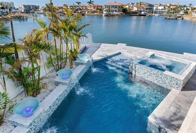 view of swimming pool featuring an in ground hot tub, a water view, and pool water feature