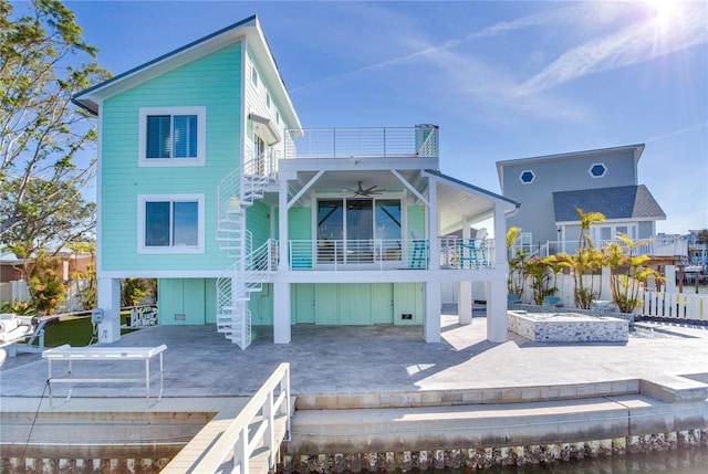 rear view of house with a patio, a balcony, and ceiling fan