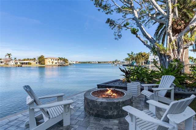 view of patio / terrace featuring a water view and an outdoor fire pit