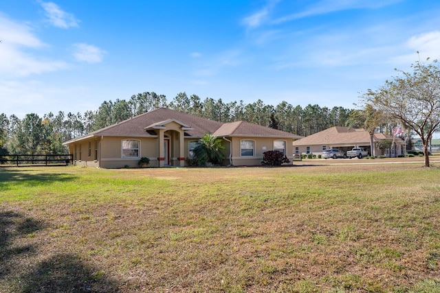 ranch-style home with a front lawn