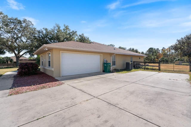 view of property exterior with a garage and central air condition unit