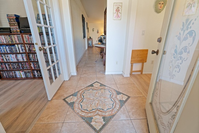 hallway with french doors and light wood-type flooring