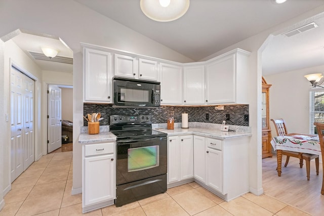 kitchen with white cabinets, black appliances, and lofted ceiling