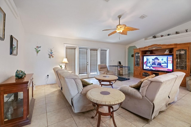 living room with ceiling fan, light tile patterned floors, and vaulted ceiling