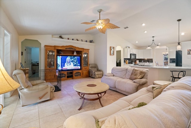 living room with vaulted ceiling, ceiling fan, and light tile patterned flooring