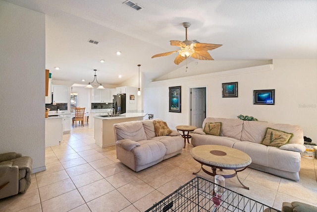 tiled living room with ceiling fan and lofted ceiling