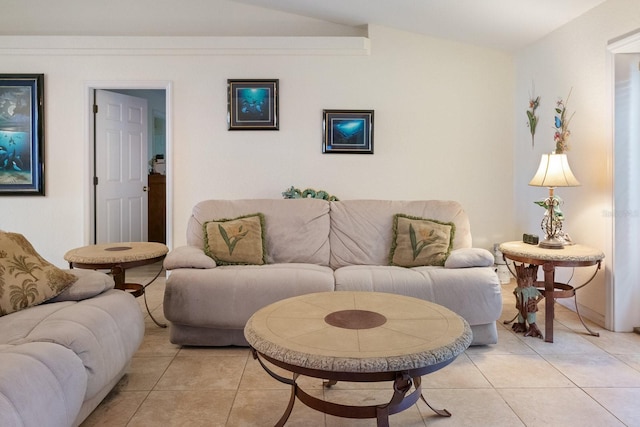 living room featuring vaulted ceiling and light tile patterned flooring