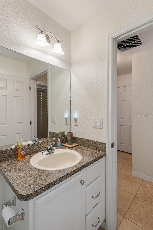 bathroom with vanity and tile patterned floors