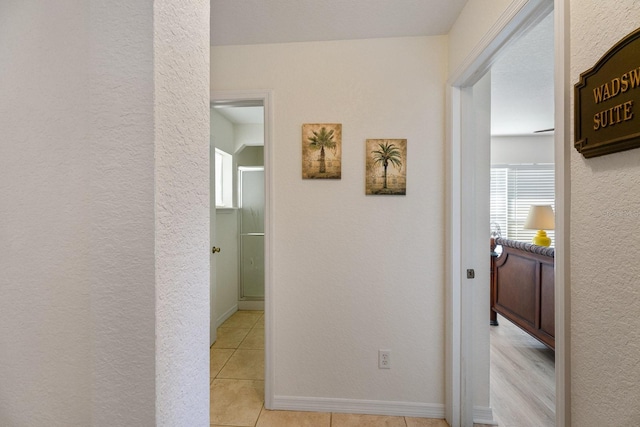 corridor with light tile patterned flooring