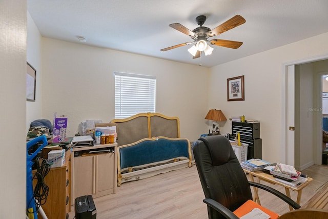 office area with light hardwood / wood-style floors and ceiling fan