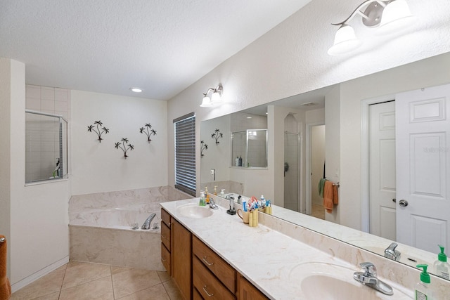 bathroom with tile patterned floors, vanity, shower with separate bathtub, and a textured ceiling