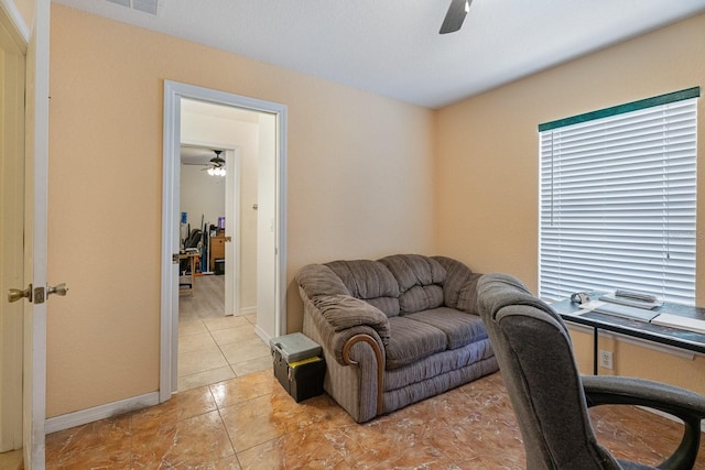 office space featuring baseboards and ceiling fan