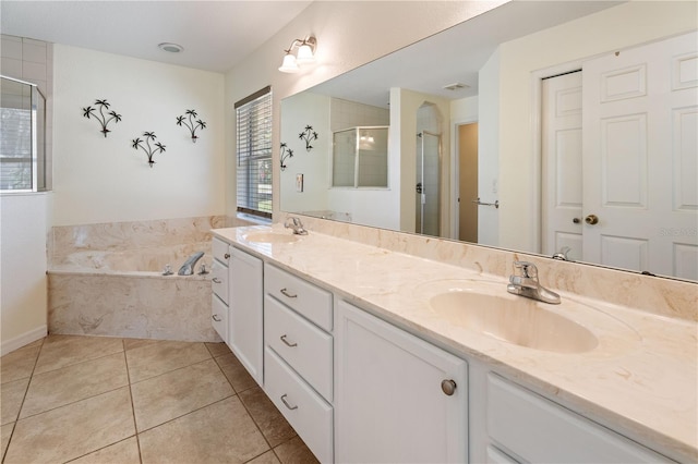 bathroom with tile patterned flooring, a sink, double vanity, and a shower stall