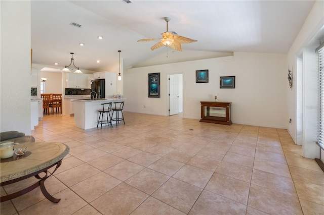 living room featuring vaulted ceiling, recessed lighting, light tile patterned flooring, visible vents, and a ceiling fan