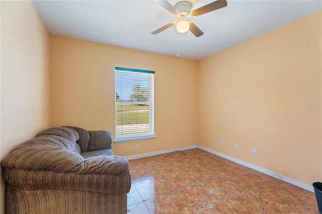 sitting room with baseboards and a ceiling fan