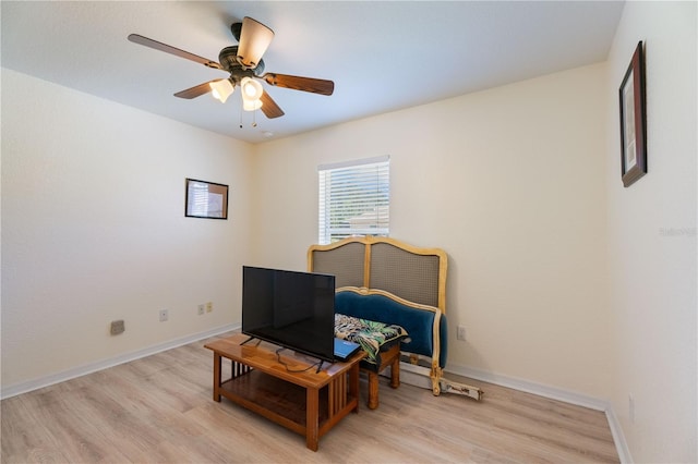 bedroom with baseboards, light wood-type flooring, and a ceiling fan