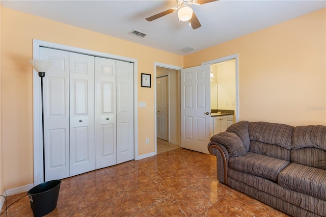 living area featuring baseboards, visible vents, and a ceiling fan