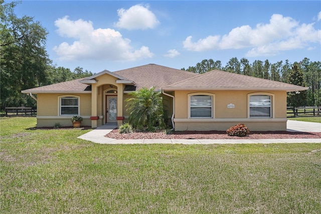 4995 County Road 121d, Wildwood, FL 34785 - view of front of home featuring stucco siding and a shingled roof