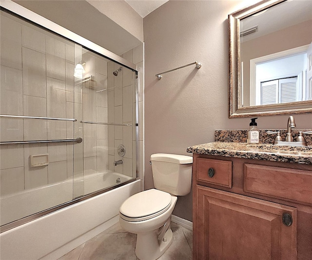 full bathroom featuring tile patterned flooring, vanity, toilet, and enclosed tub / shower combo