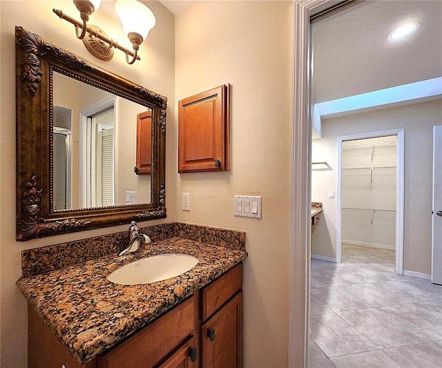 bathroom with vanity, an enclosed shower, and a notable chandelier