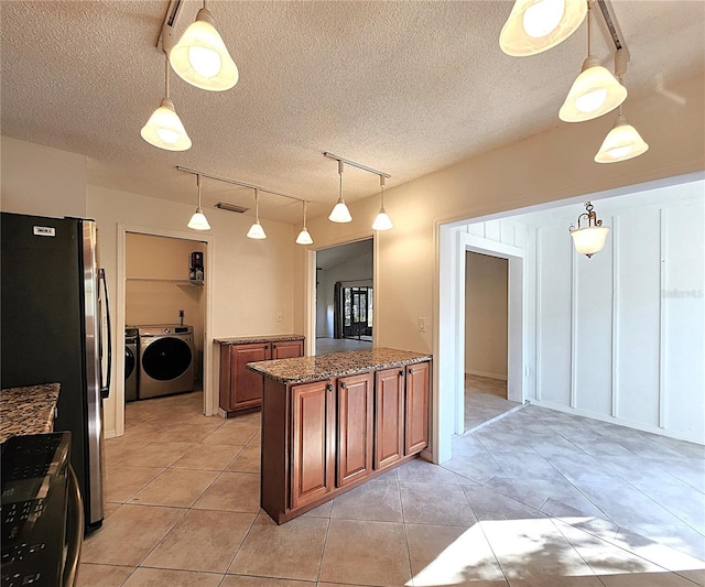 kitchen with stainless steel refrigerator, rail lighting, and pendant lighting