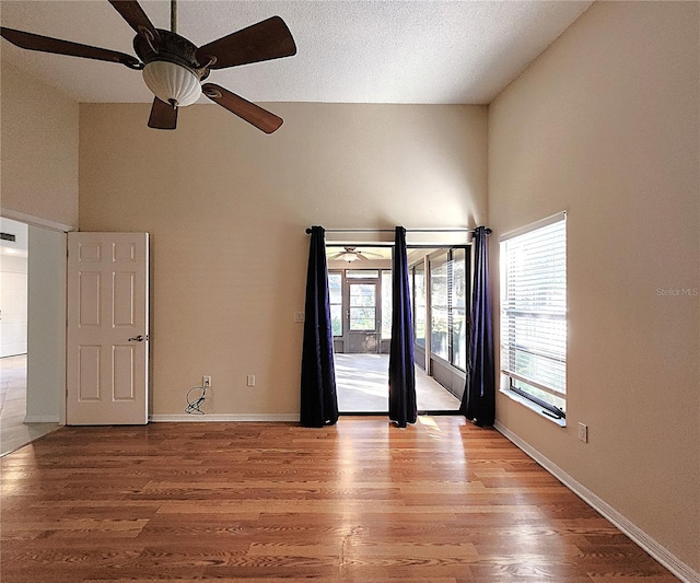 empty room featuring ceiling fan, light hardwood / wood-style floors, and a textured ceiling